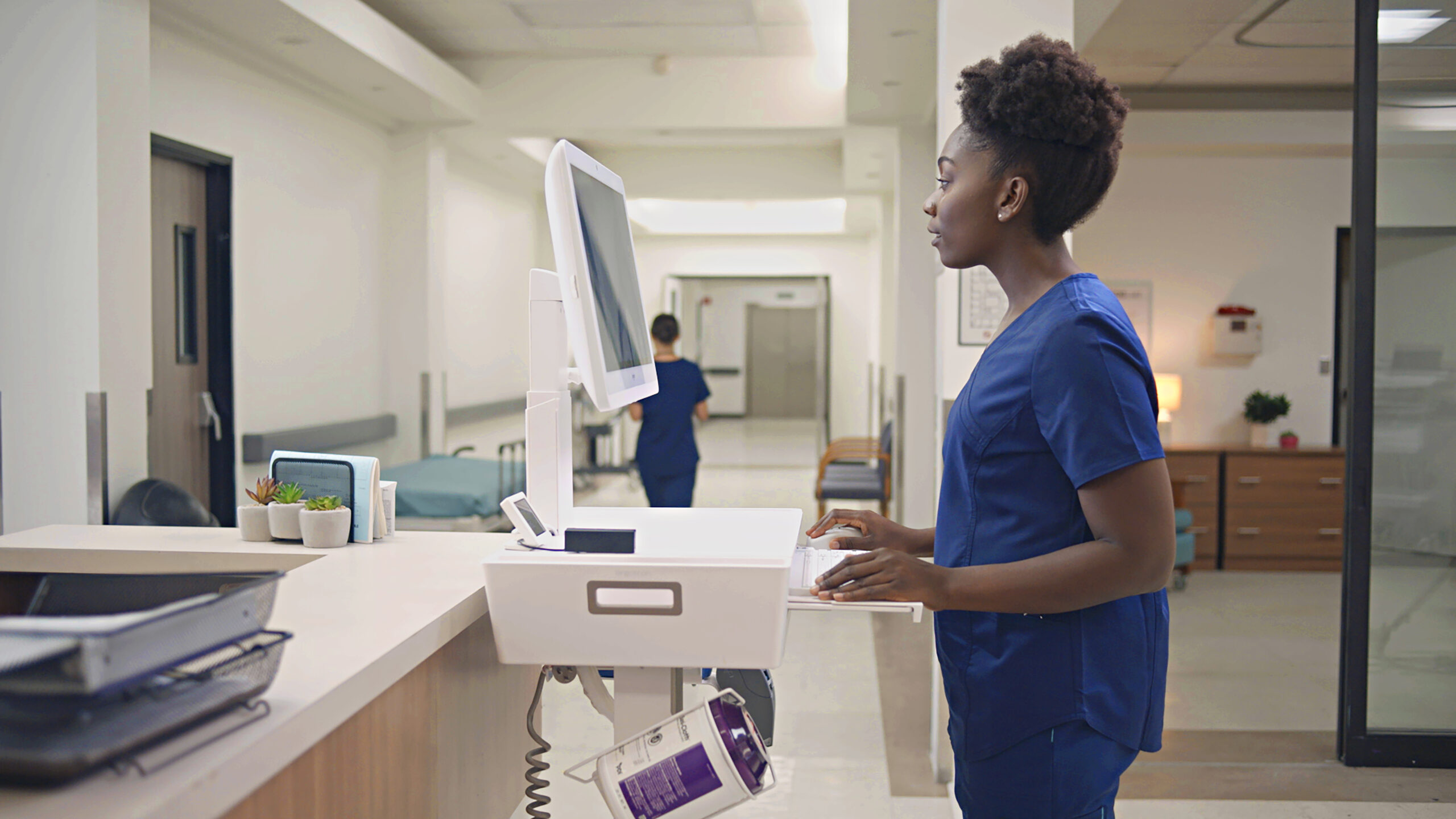 Doctor looking at computer standing up