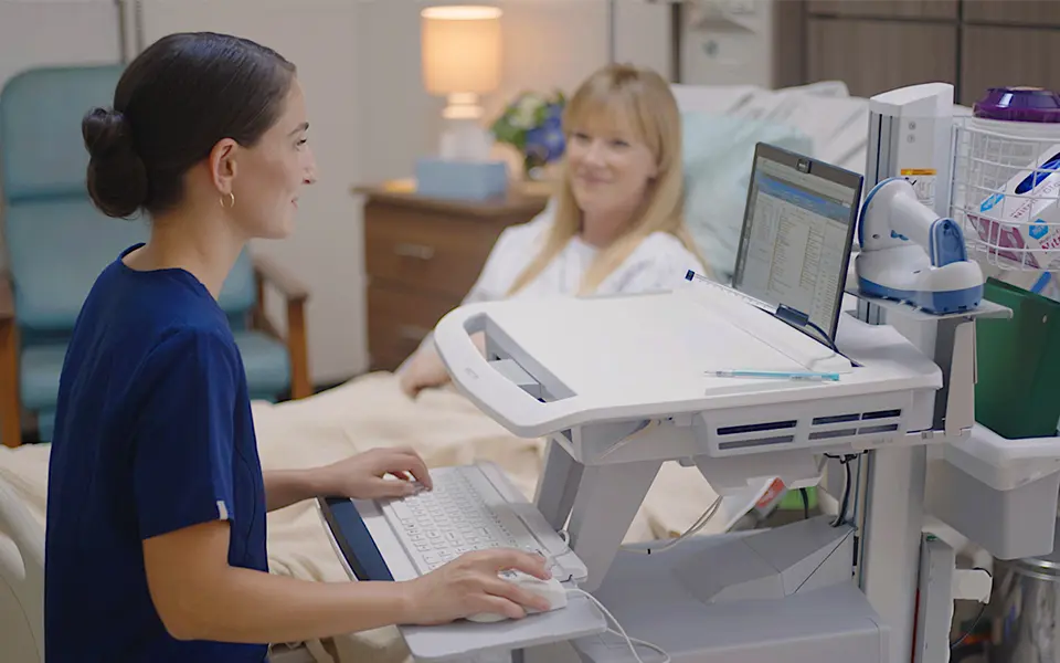 Doctor talking to patient while on computer. 